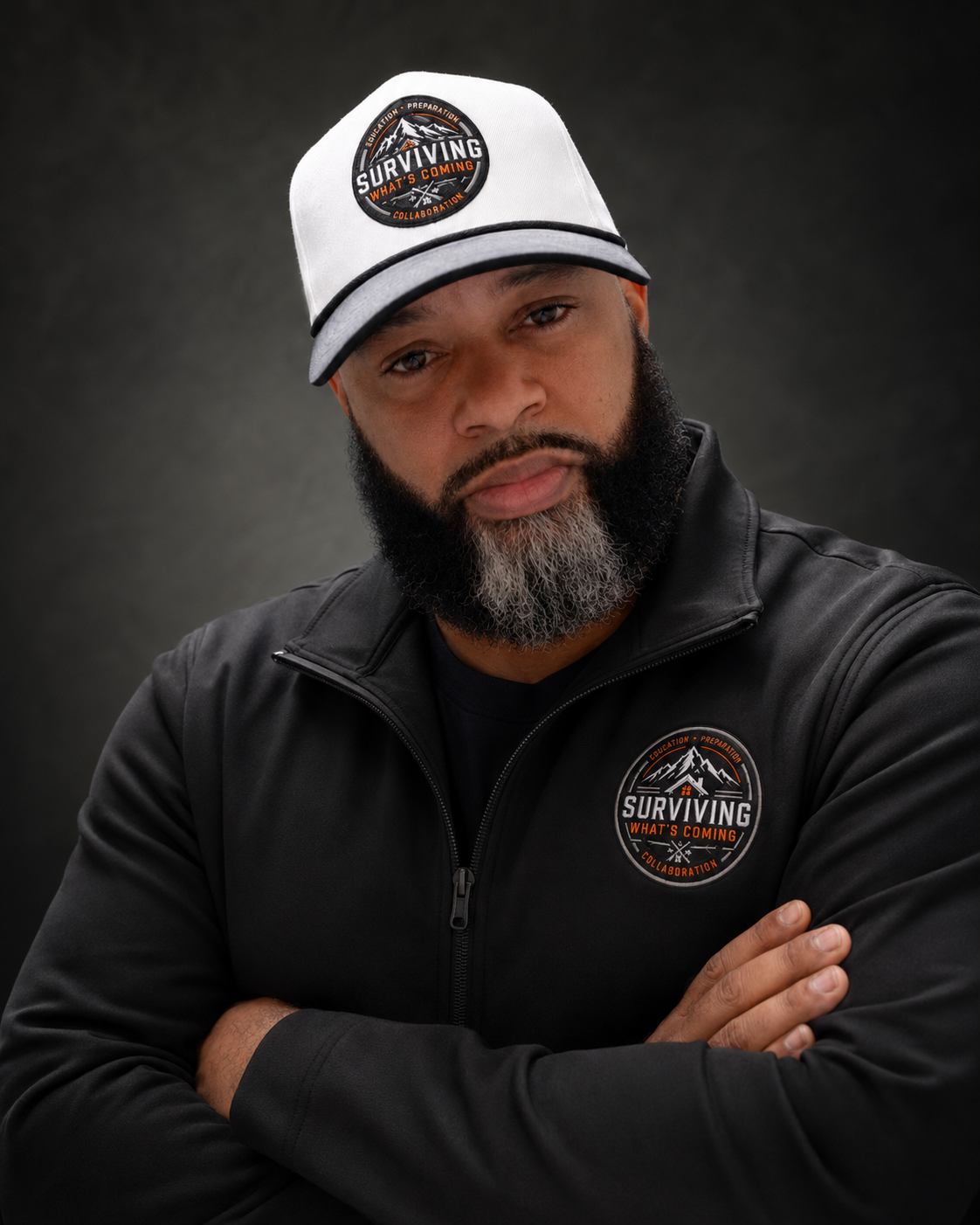 Coach Dex, founder of Surviving What’s Coming, wearing a branded cap and jacket